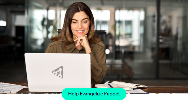 A young, working professional woman working on a laptop with a Puppet icon on the cover